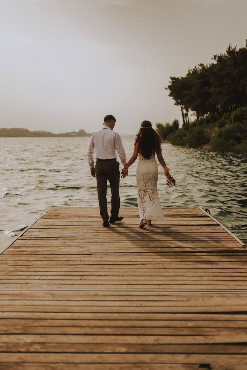 photo of couple standing on wooden planks